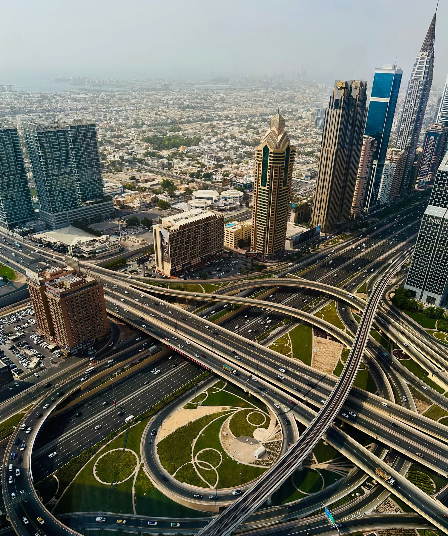 Aerial view of a Dubai highway interchange beside high-rise towers