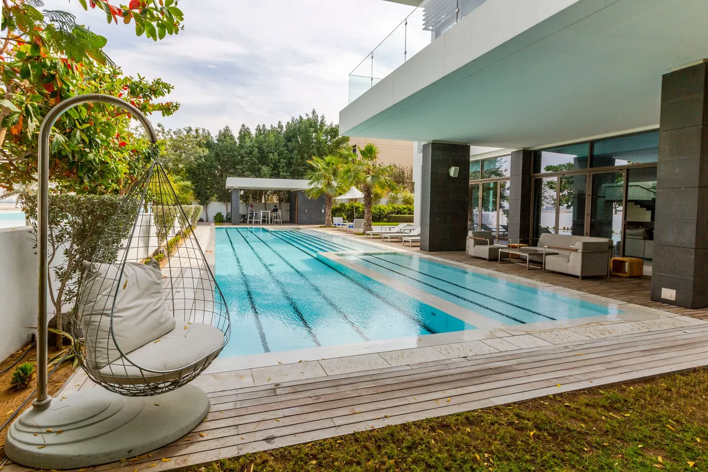 A private pool and timber terrace beside a modern villa